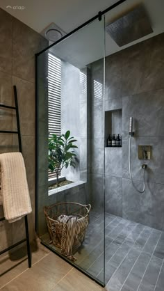 a bathroom with a walk in shower next to a window