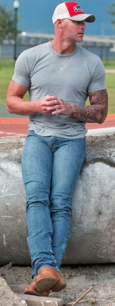 a man sitting on top of a cement bench