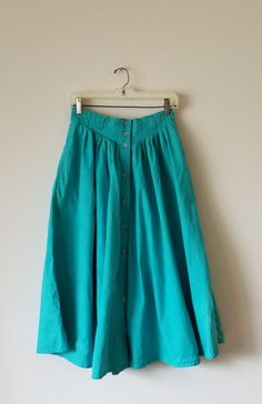 Vintage 1980's size 10 Liz Claiborne skirt. Button-front, yoked with pleats long/peasant/prairie skirt. Ankle length. Sea green. Full and flowy. Cotton fabric does not stretch. Perfect 1980s fashion with ankle boots and socks. Cottage, hippie, boho. Spring Full Skirt Bottoms With Buttons, Daywear Long Skirt With Buttons, Green Skirt With Button Closure For Spring, Buttoned Full Maxi Skirt, Green Buttoned Skirt For Summer, Vintage Green Skirt For Summer, Vintage Full Skirt Bottoms With Buttons, Vintage Skirt With Button Closure For Summer, Green Vintage Long Skirt