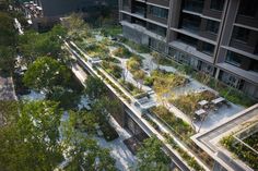 an aerial view of a building with many plants growing on the roof and in the courtyard