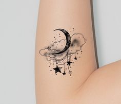 a woman's thigh with a crescent and stars tattoo on it