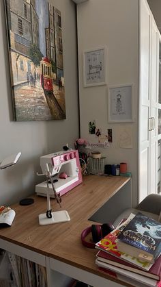 a sewing machine sitting on top of a wooden table next to a book shelf filled with books