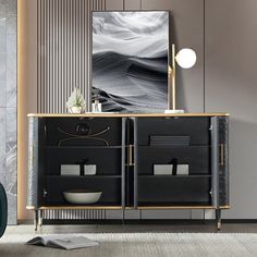 a black and gold sideboard in a living room next to a painting on the wall