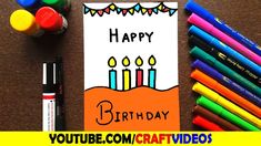 a birthday card with candles and crayons next to it