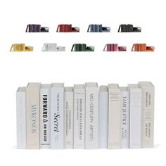 a row of books sitting on top of each other in front of a white background