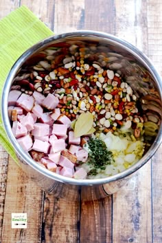 a pot filled with food sitting on top of a wooden table