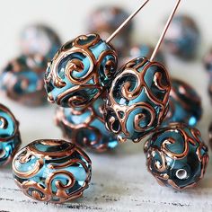 several blue and gold beads are sitting on a table