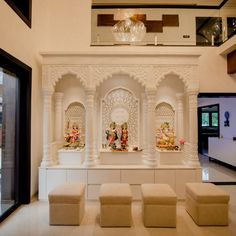 a living room filled with lots of white furniture