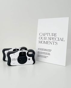 two cameras sitting next to each other in front of a sign that says capture our special moments