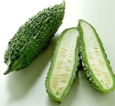 two pieces of cucumber sitting next to each other on a white counter top