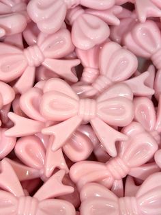 pink candy candies with bows and hearts on them are shown in close up view