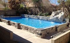 an empty swimming pool in the middle of a backyard