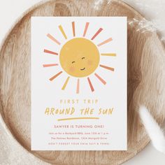 a wooden plate with a card that says, first trip around the sun