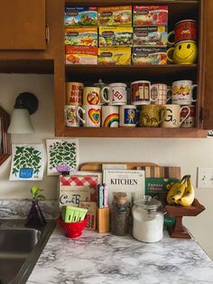 the kitchen counter is full of spices, books and other items that are on display