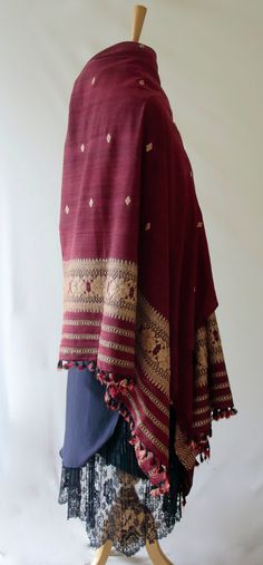 A hundred percent Eri Silk Shawl that can also be used as a Dupatta to complement your Indian Ethnic suits.  The motifs are woven in Ghica silks . The motifs are typical of the region and are widely used in the traditional wear.  Since Eri Silk is there, the stole / dupatta does not have the typical sheen that is associated with Silks from India.  Eri Silk is an indigenous Silk variety from India found in Assam and some other North Eastern States. Eri Silk is the original Assam Silk. The lack of Traditional Handloom Wear For Festival, Festive Woven Motifs Dupatta For Rituals, Festive Pashmina Dupatta With Woven Motifs, Festive Dupatta With Woven Motifs For Rituals, Folk Style Dupatta With Woven Motifs, Folk Style Handloom Dupatta For Festivals, Bohemian Traditional Wear With Woven Motifs For Festive Season, Traditional Festive Shawl With Woven Motifs, Festive Pashmina Handloom Shawl