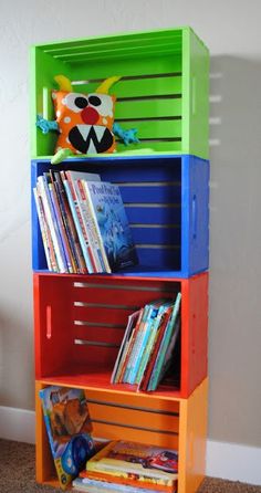 a colorful book shelf with books on it and a stuffed animal head above the top