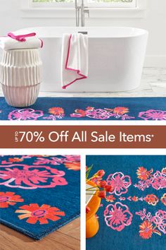 bathroom rugs with pink and orange flowers on them, next to a bathtub