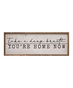 a wooden sign that says take a deep breath, you're home now