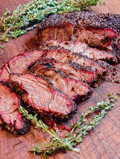 sliced up steak with herbs on the side