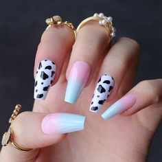 a hand with some white and black nail designs on it