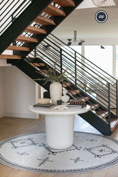 Beautiful entryway decor featuring a machine washable round rug. Marble Kitchen Island, Reclaimed Wood Floating Shelves, Black And White Rug, Beautiful Entryways, Black White Rug, Vintage Inspired Decor, Wood Floating Shelves, Home Entrance Decor, Kitchen Marble