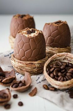 three chocolate eggs in nests with coffee beans