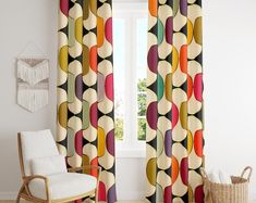 the curtains in this living room are colorfully designed and have circles on them, as well as fringes