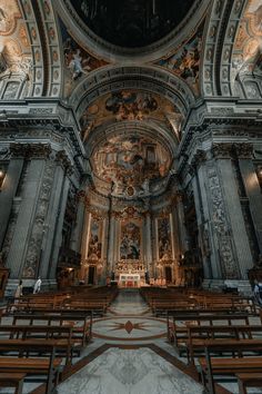 the inside of an old church with pews