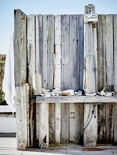 an old wooden bench sitting in front of a fence