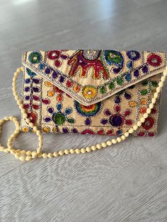 Indian handmade boho style handbag . hand embroidery all over . use as clutch bag or cross body . very lightweight Bohemian Beaded Shoulder Bag For Summer, Summer Bohemian Beaded Shoulder Bag, Multicolor Embroidery Crossbody Shoulder Bag, Multicolor Embroidered Handwork Clutch, Bohemian Beige Shoulder Bag With Floral Embroidery, Summer Beaded Bag Fashion Accessory, Summer Beaded Bags As Fashion Accessory, Traditional Crossbody Shoulder Bag With Multicolor Embroidery, Summer Fashion Beaded Bag