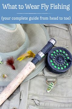 a fly fishing rod, hat, and lure on the ground with text overlay that reads what to wear fly fishing your complete guide from head to toe