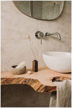 a bathroom sink sitting on top of a wooden counter