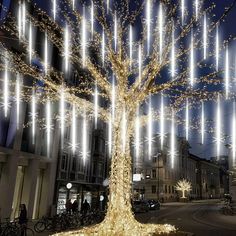 a lighted tree in the middle of a street