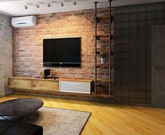 a living room with brick wall and wooden flooring, television set on the wall