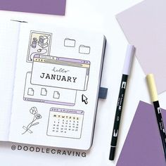 an open notebook with the word january written on it next to some markers and pens