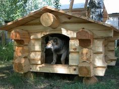 a dog house made out of wooden logs