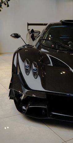 a black and white sports car parked in a showroom