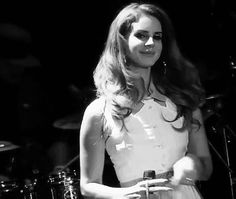 a woman standing in front of a drum set