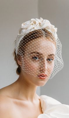 a woman wearing a veil with flowers on it