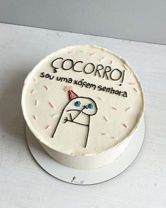 a white cake decorated with an image of a man's face and the words cocoro on it