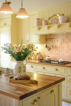 a vase filled with flowers sitting on top of a wooden counter