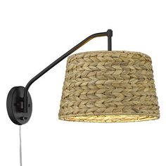 a wall light with a woven shade on the arm and an iron rod attached to it