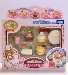 an assortment of miniature desserts in a box on a white surface with japanese writing