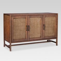 a wooden cabinet with two doors and wicker panels on the front, against a white background