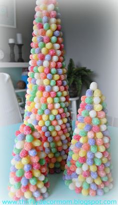 three small trees made out of candy balls