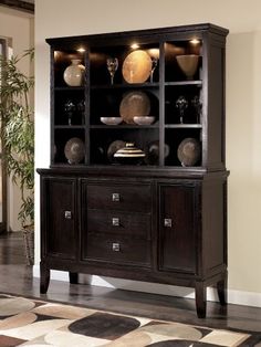 a large wooden cabinet with glass doors and shelves