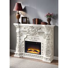 a white fireplace with an electric fire in it