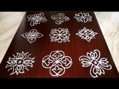 a wooden table topped with lots of white designs on it's top and bottom