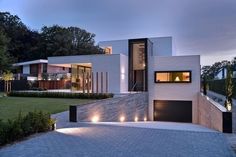 a modern house is lit up at night