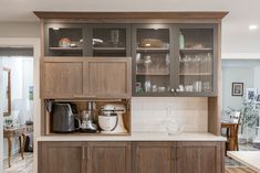 a kitchen with wooden cabinets and white counter tops